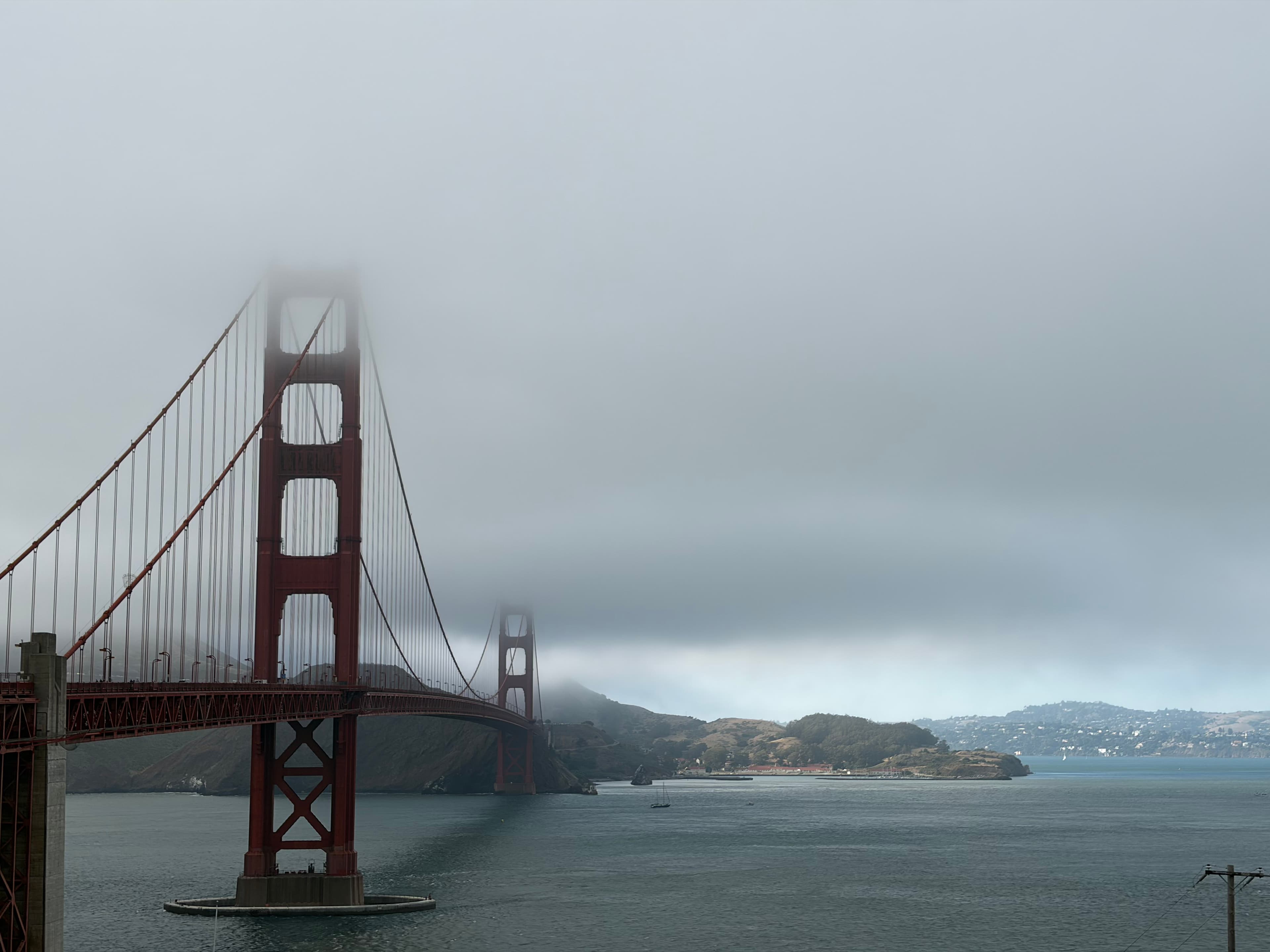 Golden Gate Bridge emerging from fog over San Francisco Bay